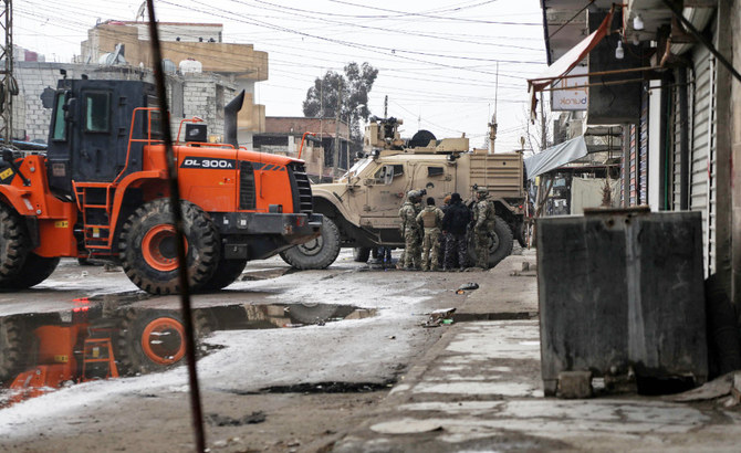 US soldiers accompanied by members of the Syrian Democratic Forces (SDF) gather in the neighbourhood of Ghwayran in the northeastern Syrian city of Hasakeh, on January 29, 2022. (AFP)