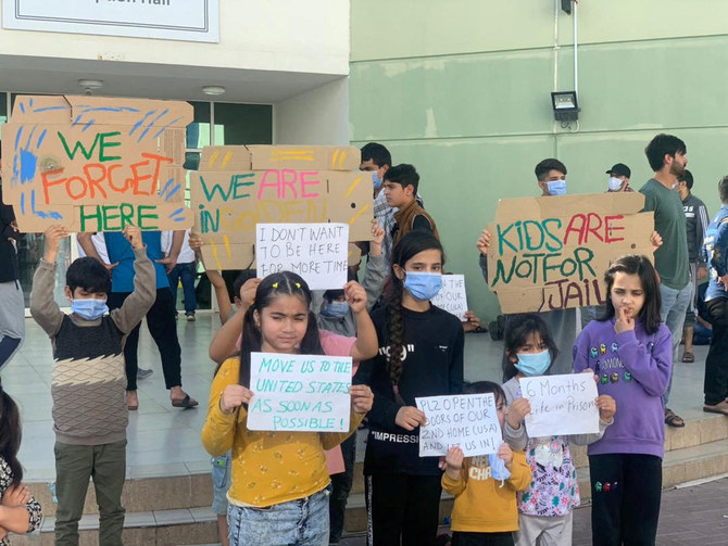 Afghan children hold a rally at a Gulf facility in in Abu Dhabi, United Arab Emirates, to protest the lengthy US relocation process. (Rise to Peace/via REUTERS)