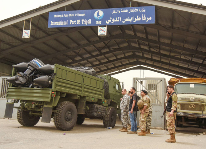 Lebanese army soldiers stand near a vehicle entering port of Tripoli after a boat capsized off the Lebanese coast of Tripoli overnight, in Tripoli, northern Lebanon April 24, 2022. (REUTERS)