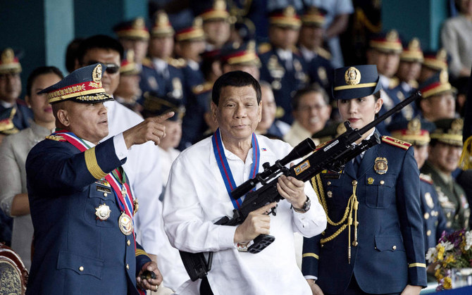 Philippine President Rodrigo Duterte (C) holding a Galil sniper rifle in Manila. (AFP file photo)