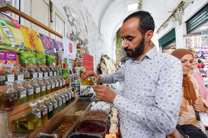 Tunisian perfumer Zouhaier Ben Abdallah blends jasmine extracts at his bazaar shop in the Old City of Tunis. (AFP)