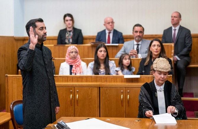 Leader of the Scottish National Party (SNP), Humza Yousaf (L), is sworn in as Scotland's First Minister at the Court of Session.