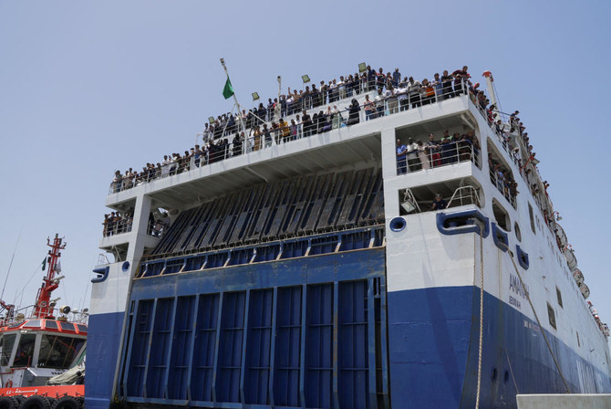 Civilians onboard a commercial ship are seen as it docks at Jeddah Sea Port, evacuated by Saudi Arabia from Sudan to escape