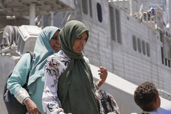 US citizens and other nationalities disembark from a US Navy fast transport ship to escape the conflict, at the Jeddah Sea Port.