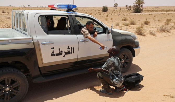 Libya border guards rescue migrants in desert near Tunisia