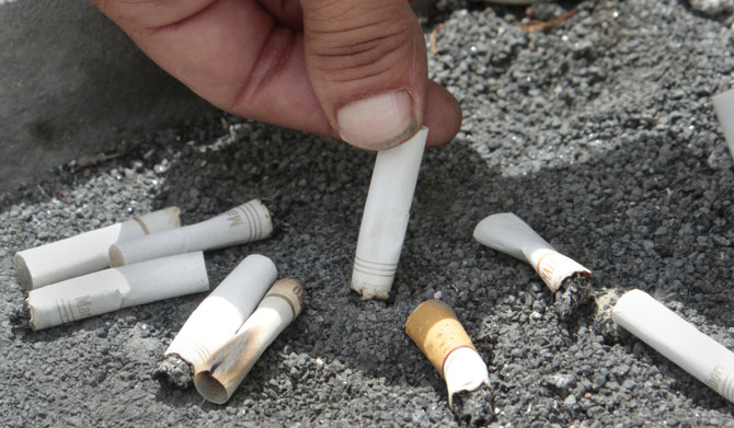 A smoker snuffs out a cigarette at the Capitol in Sacramento, Calif. (AP)