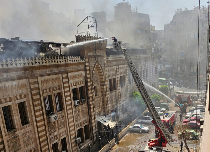 Egyptian firefighters extinguish a fire that broke out in the historic building of the Ministry of Religious Endowments in Cairo