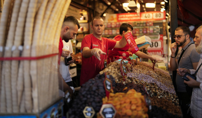 Food shop sellers attend clients in a street market at Eminonu commercial district in Istanbul, Turkey, Wednesday, Sept. 6, 2023