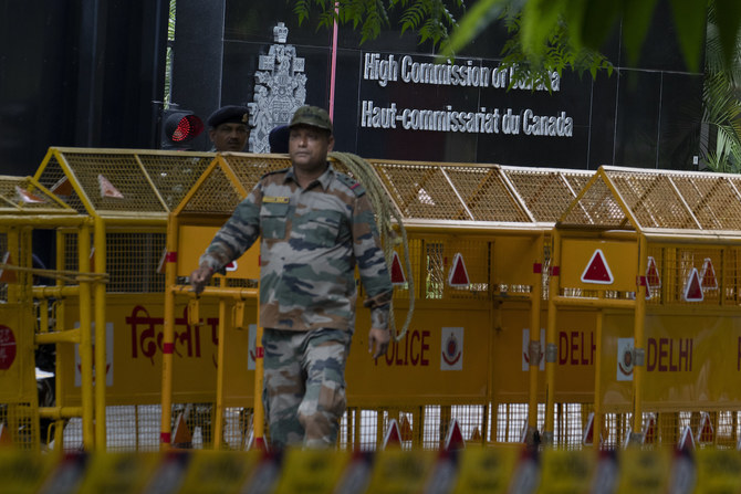 An Indian paramilitary soldier stands guard next to a police barricade outside the Canadian High Commission in New Delhi, India.