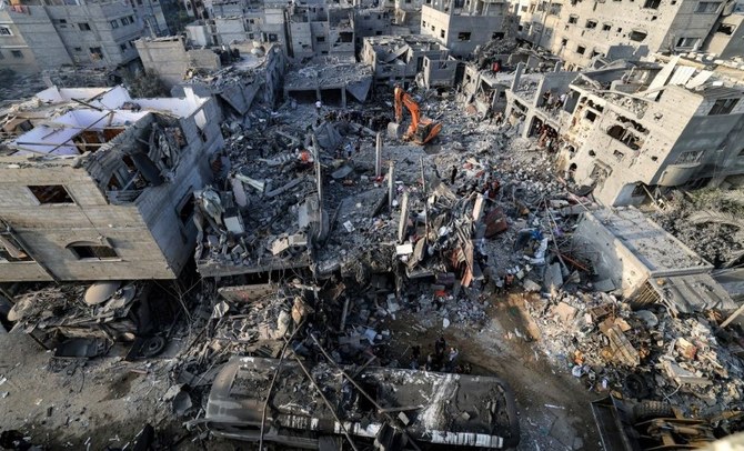 People search for survivors and the bodies of victims in buildings that were destroyed during the Israeli bombardment.