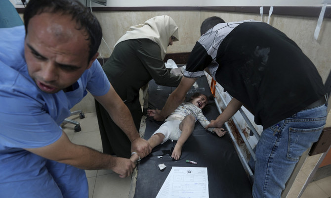 Bodies line Gaza hospital wall and surgeons operate in corridors