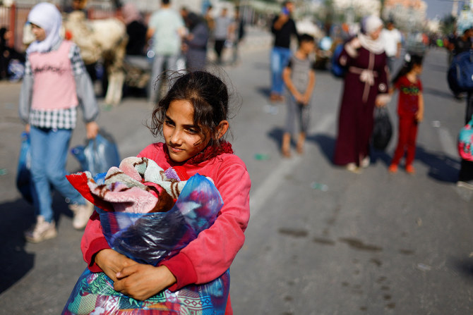 A girl carries a bag, as Palestinians fleeing north Gaza head towards the south on November 9, 2023. (Reuters)