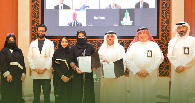 Officials pose for a group photo after signing the deal. (Photo: Twitter @kauweb)