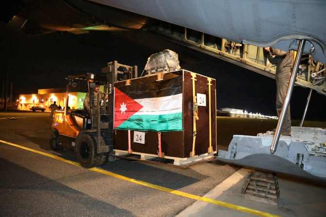 Members of the Jordanian military load humanitarian aid into a plane to be airdropped to a church in Gaza on Christmas Eve.