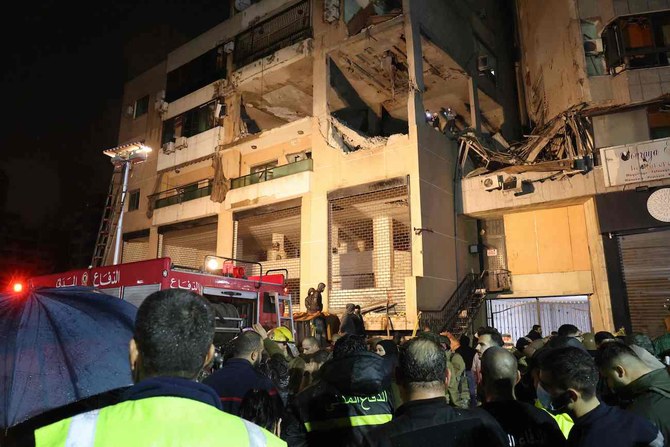 Lebanese emergency responders gather at the site of a strike targeting a Hamas office, in the southern suburb of Beirut.