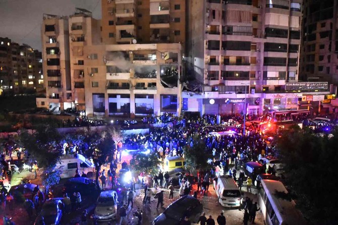 People gather at the site of a strike, reported by Lebanese media to be an Israeli strike targeting a Hamas office.