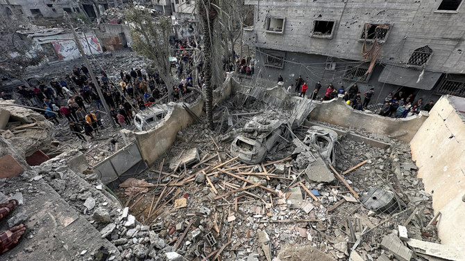 Palestinians inspect the site of an Israeli strike on a house, amid the ongoing conflict between Israel and Hamas, in Jabalia.