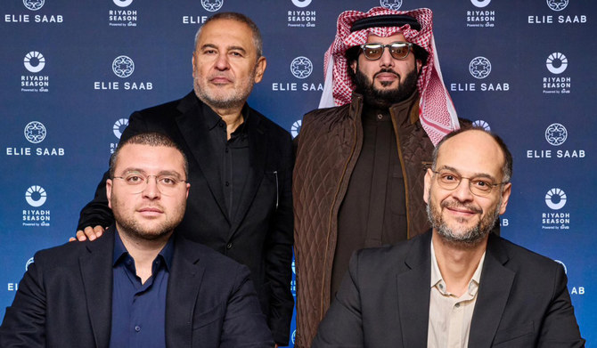 Faisal Bafarat, right, and Elie Saab Jr. sign an MoU in London with Turki Al-Sheikh and Elie Saab present. (Supplied)