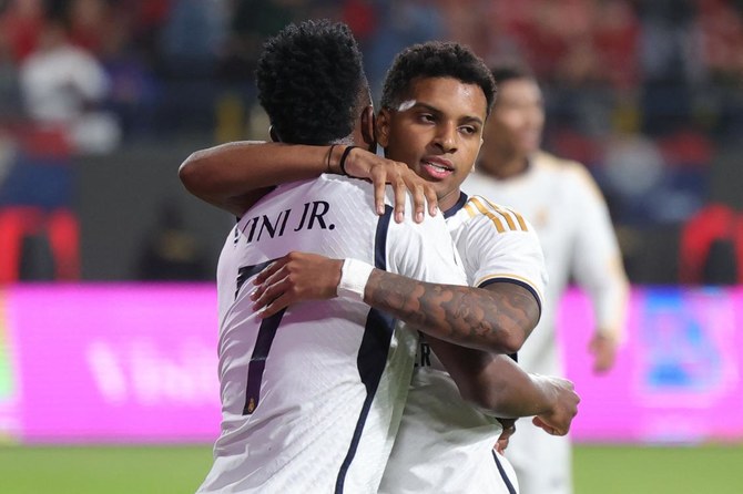 Real Madrid's Brazilian forward Vinicius Junior congratulates teammate Brazilian forward Rodrygo.