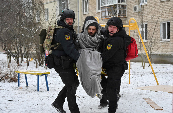 Ukraininan Police officers carry a local resident injured as a result of a missile attack in Kharkiv on January 23, 2024. (AFP)