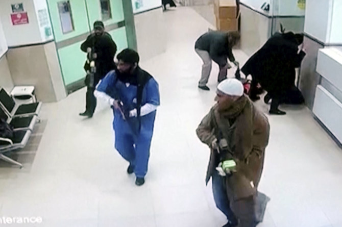 Israeli forces disguised as civilians and medical workers hold weapons in a hallway at the Ibn Sina Hospital in the West Bank.