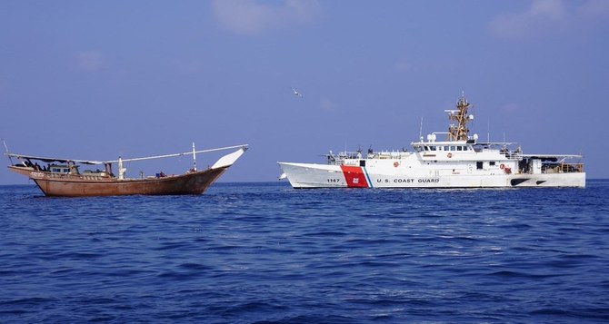 A US navy cutter can be seen next to a vessel reportedly carrying a shipment of Iranian weapons destined for the Houthis.