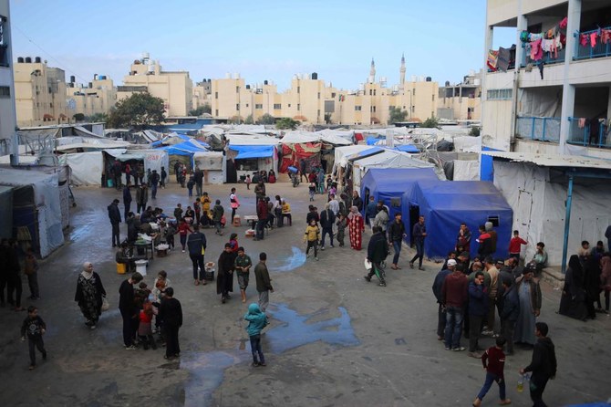 Displaced Palestinians walk around in an UNRWA school housing displaced Palestinians, in Rafah in the southern Gaza Strip.