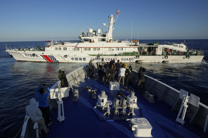 China coast guard flexes its might against the Philippines in disputed waters as journalists look on