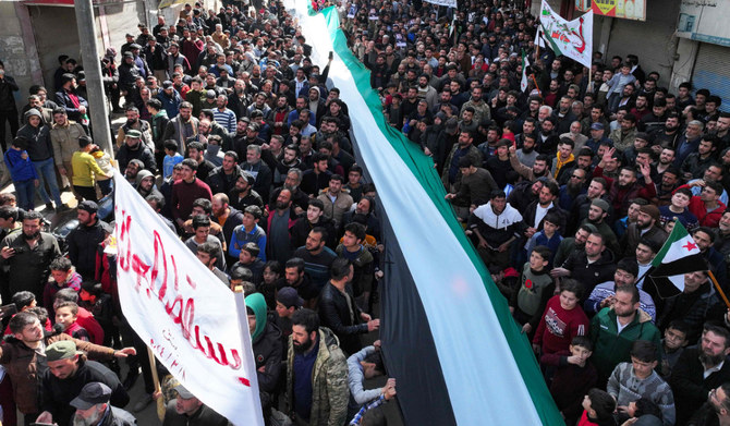Protesters march in Syria against Al-Qaeda-linked group as a prominent  militant is released