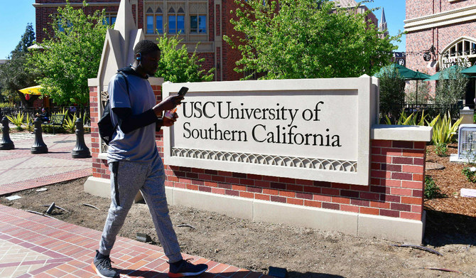 A man looks at his cellphone while walking at the University of Southern California (USC) in Los Angeles, California. (AFP)