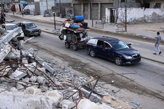 Palestinians transport their belongings as they flee Rafah in the southern Gaza Strip toward a safer area on May 12, 2024. (AFP)