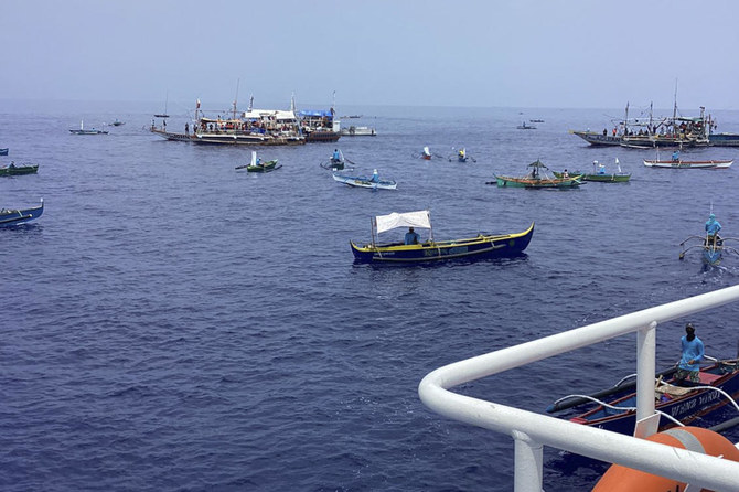 Filipino activists and fishermen sail in 100-boat flotilla to disputed shoal guarded by China