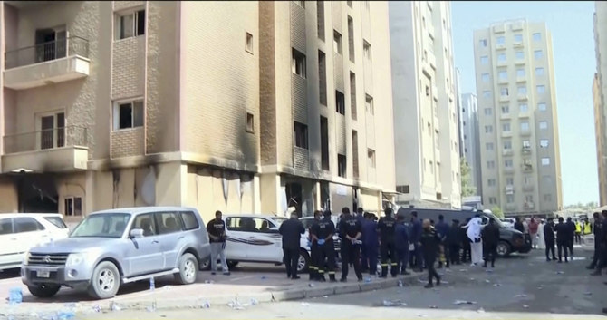 Rescuers arrive at the site of a building that caught fire in Kuwait, Wednesday, June 12, 2024. (AP)