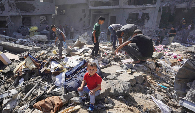 Palestinian residents search the rubble of a family home destroyed in Israeli strikes in the central Gaza Strip on Tuesday. (AFP