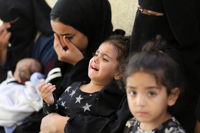 Mourners react next to the bodies of Palestinians, killed in Israeli strikes due to a military operation in Rafah.