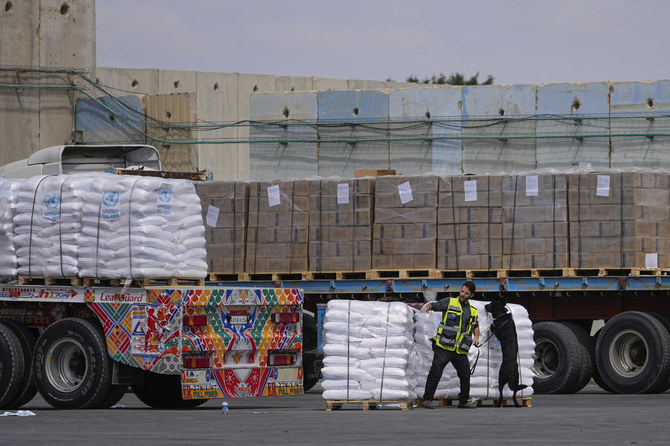 Trucks carrying humanitarian aid for the Gaza Strip pass through the inspection area at the Kerem Shalom Crossing.