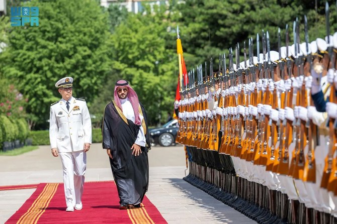 Saudi Defense Minister Prince Khalid bin Salman is received by his Chinese counterpart Dong Jun in Beijing on Tuesday. (SPA)