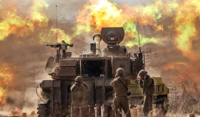 An Israeli army M109 155mm self-propelled howitzer fires rounds near the border with Gaza in southern Israel on October 11, 2023