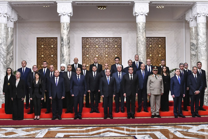 Egyptian President Abdel-Fattah El-Sissi poses with Egypt’s new cabinet, led by Prime Minister Mostafa Madbouly, fourth left.