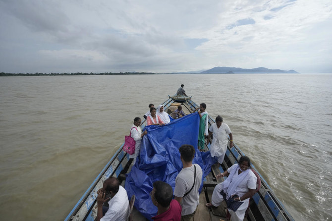 Indian mother delivers baby on boat as her river island is inundated by floodwaters