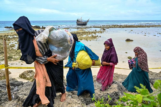 Rohingya women refugees leave the beach for their tents at Balohan ferry port in Sabang, Indonesia’s Aceh province. (File/AFP) 