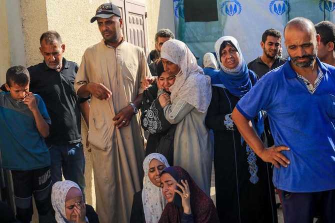 Palestinians mourn over the bodies of loved ones following Israeli bombardment in Deir El-Balah in the central Gaza Strip.