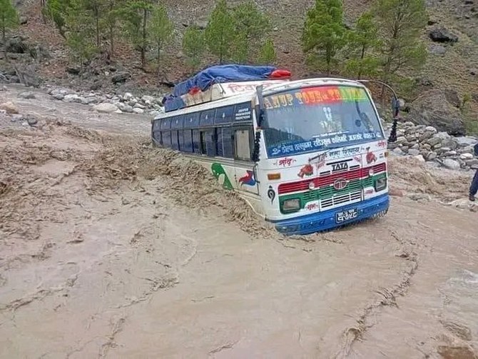 Search for dozens missing after landslide sweeps buses into Nepal river is suspended