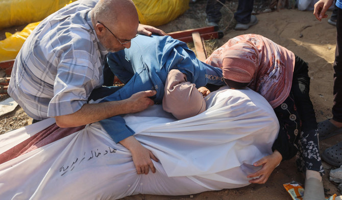 Emergency workers uncover dozens of bodies in a Gaza City district after Israeli assault