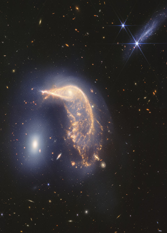 Webb Space Telescope’s latest cosmic shot shows pair of intertwined galaxies glowing in infrared
