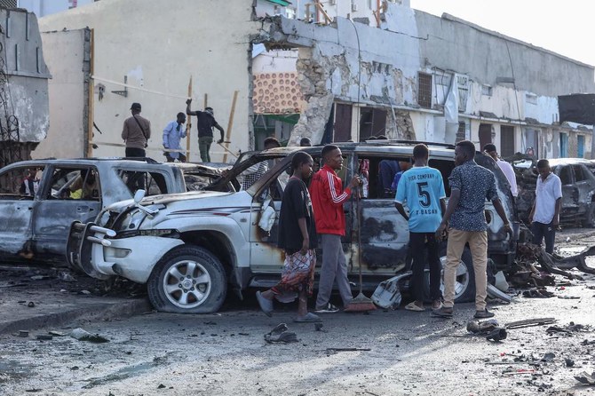 People look at the destruction at a cafe in Mogadishu on July 15, 2024 following a car bomb blast.