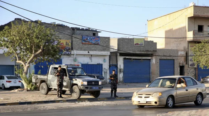 Security personnel affiliated with the Ministry of Interior secure the streets after clashes between armed factions in Tripoli.