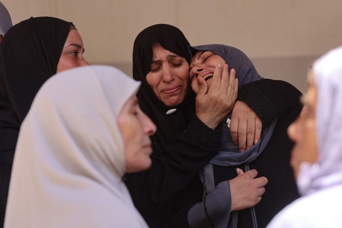 Palestinian women mourn a family member killed in Israeli bombardment, at Al-Maamadani Hospital in Gaza City on July 17, 2024. 