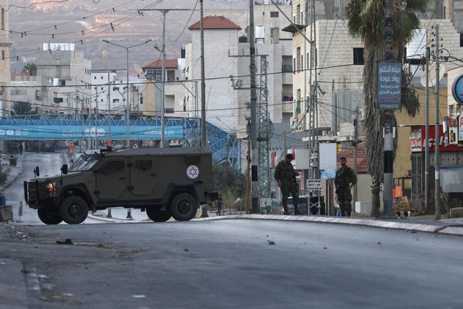 Israeli security forces close-off a main entrance to Huwara town in the occupied West Bank following attacks by Israeli settlers