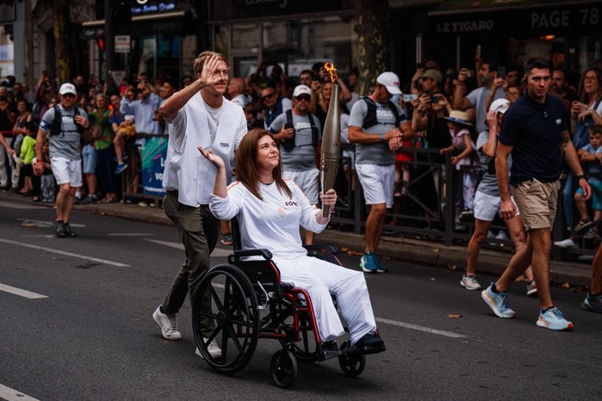 Lebanese photojournalist, wounded in Israeli strike, carries Olympic torch to honor journalists